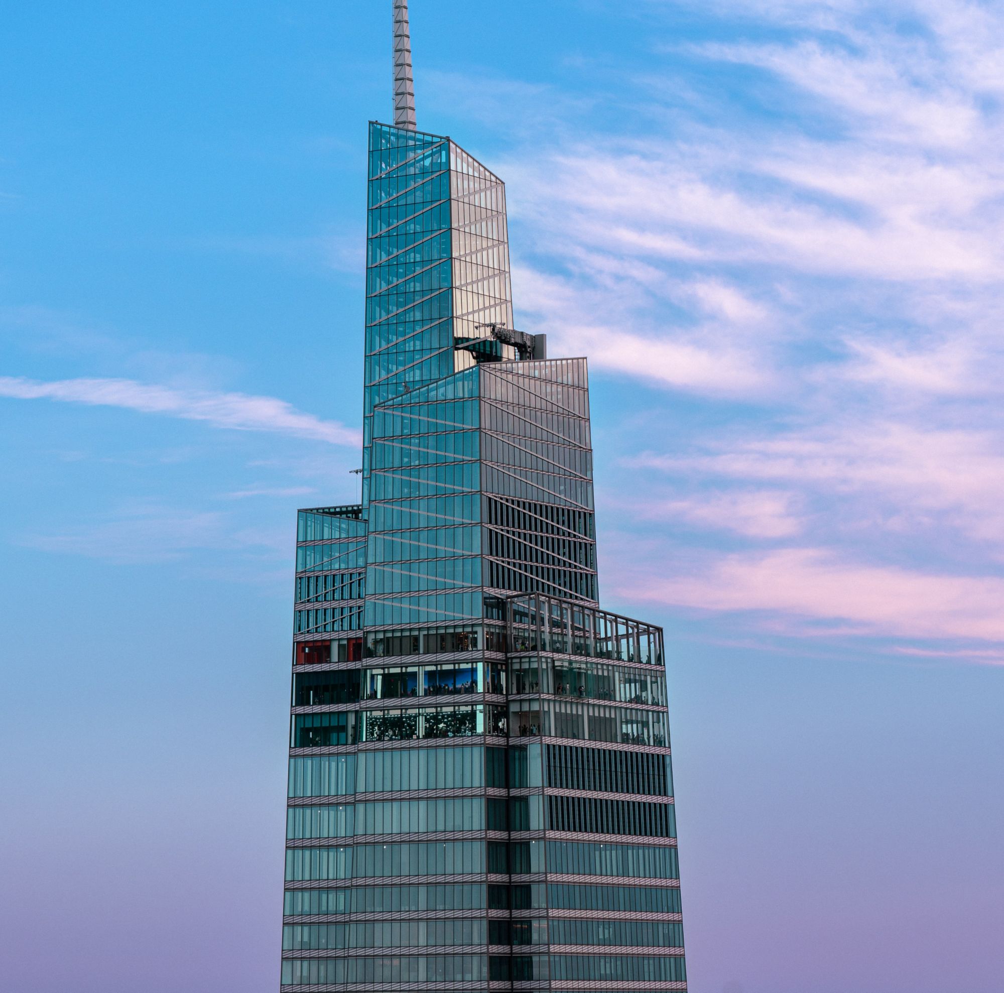 One Vanderbuilt skyscraper with modern glass facade against a blue sky 